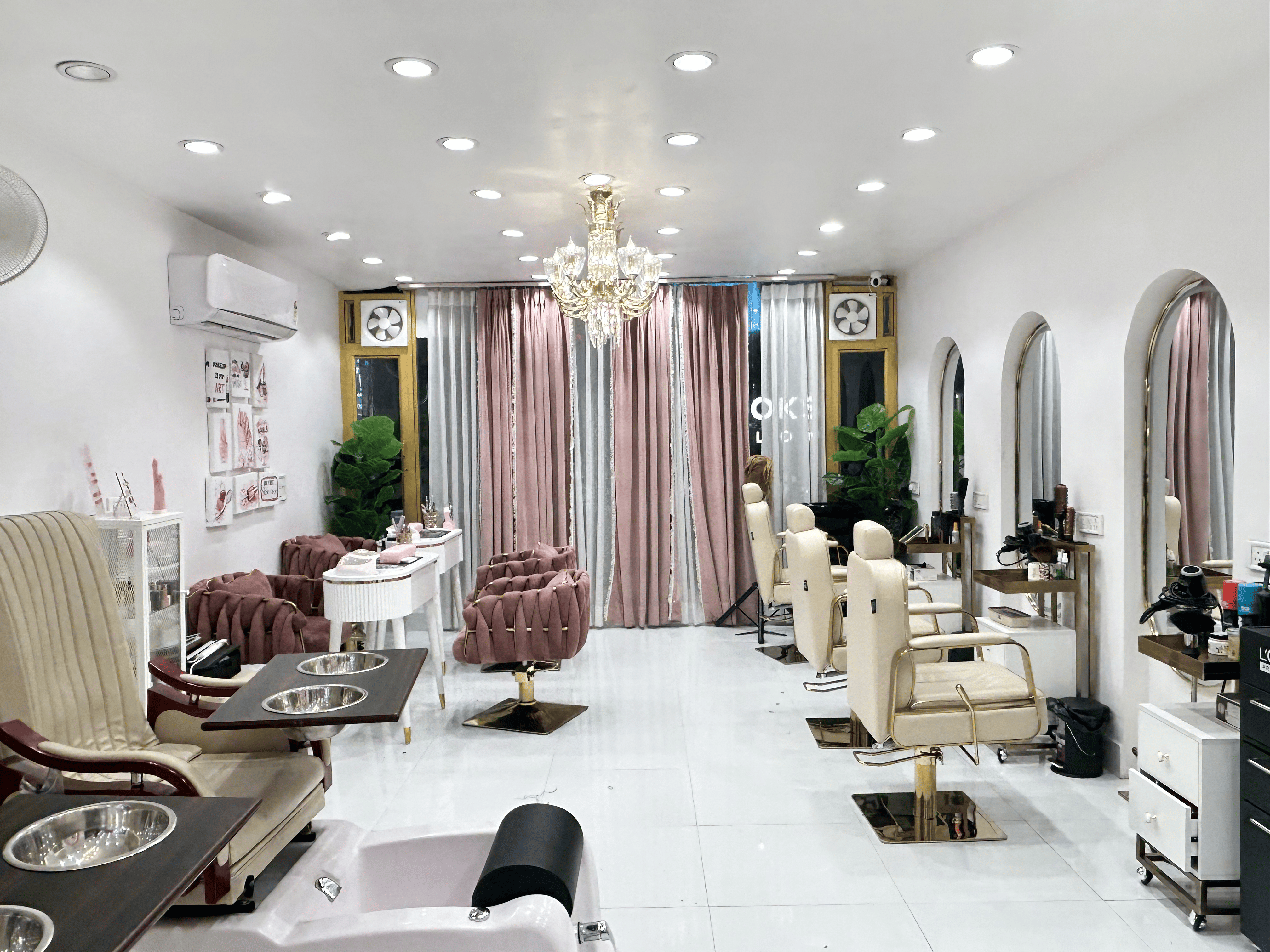 The elegant interior of Slay By Salina salon with styling chairs and round mirrors