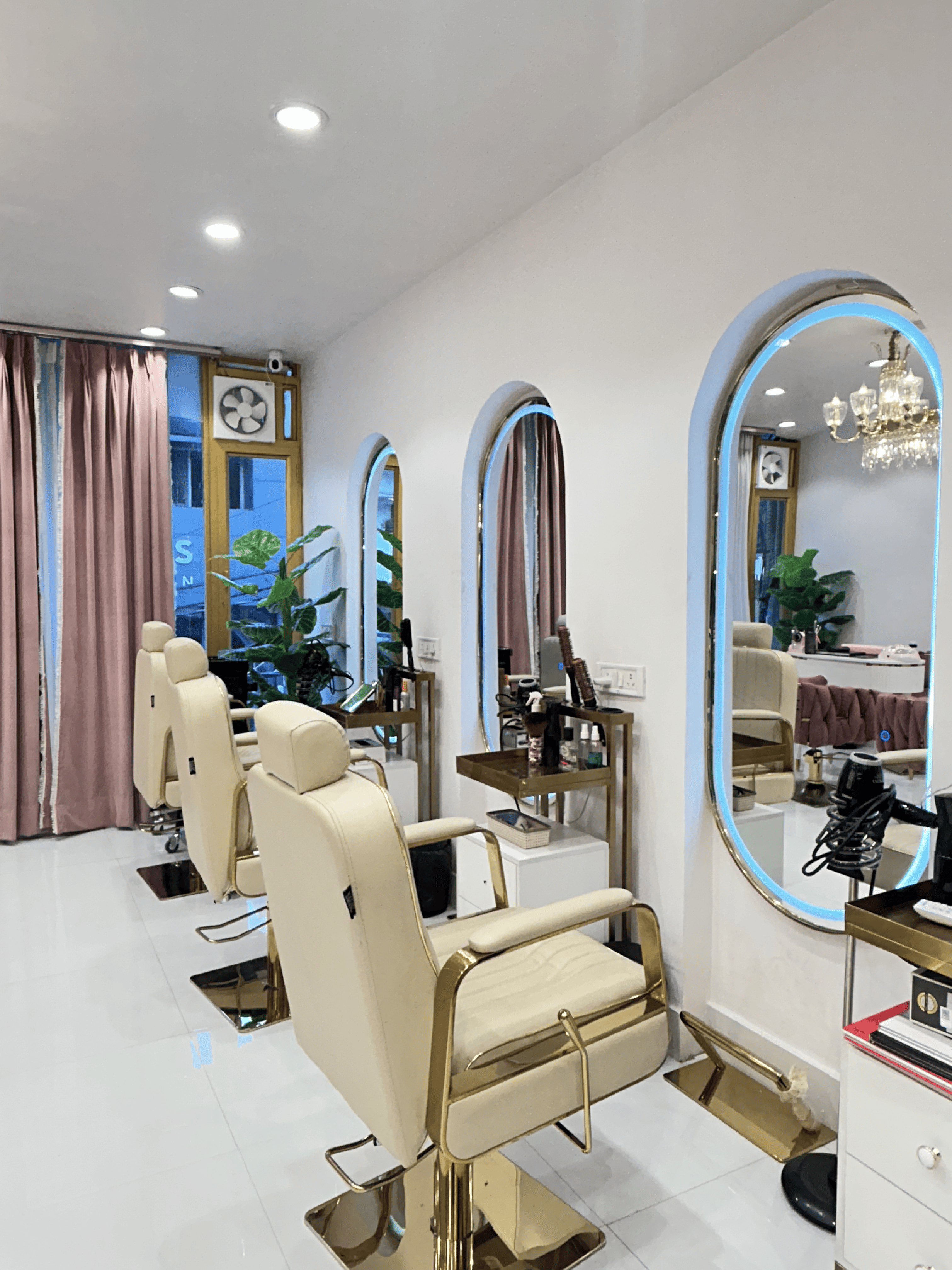 A stylist blow-drying a client's hair in the Slay By Salina studio